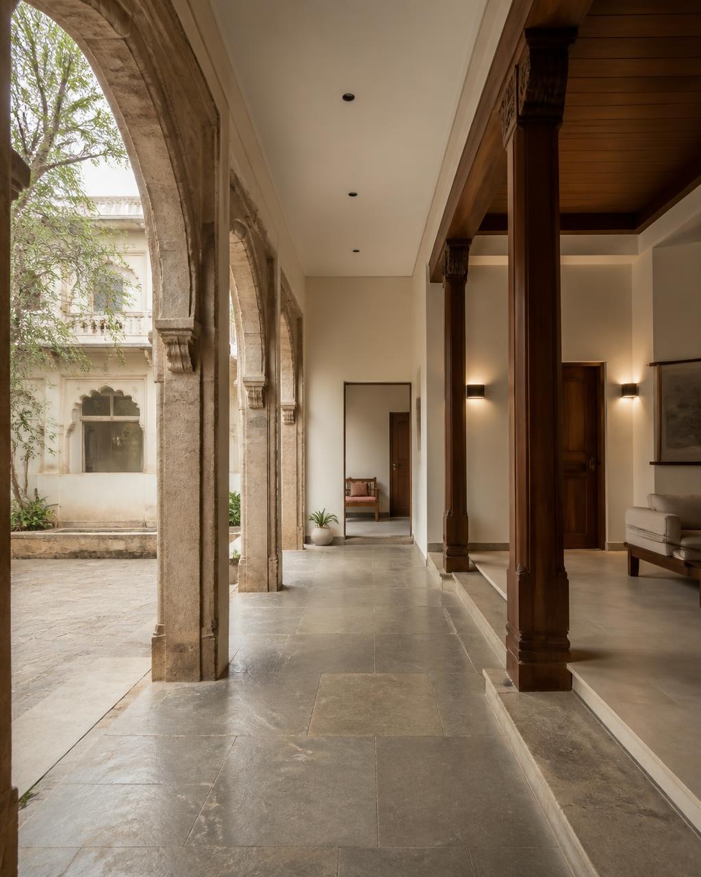 Renovated heritage Indian home where Kota stone arches meet new ivory plaster and modern lighting